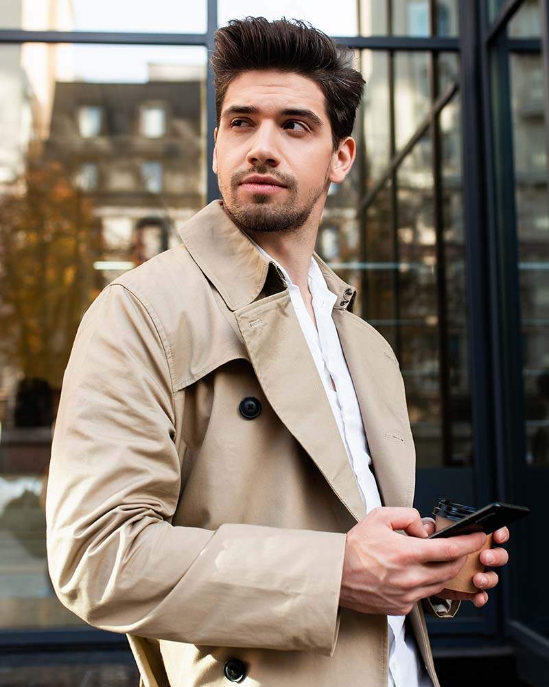 young-handsome-casual-man-in-trench-coat-with-cell-SX8Y9PF.jpg